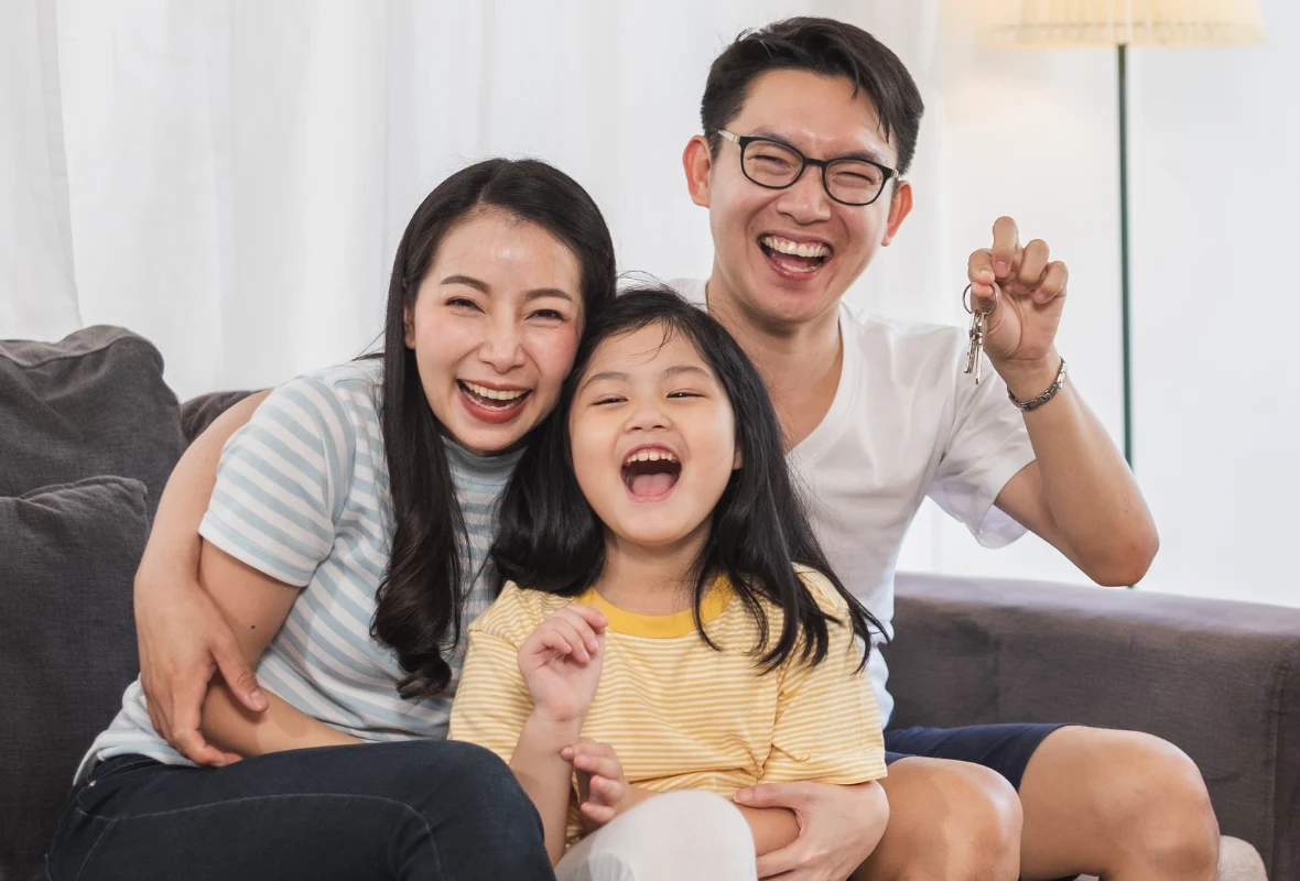 A family celebrating with the keys to their new home